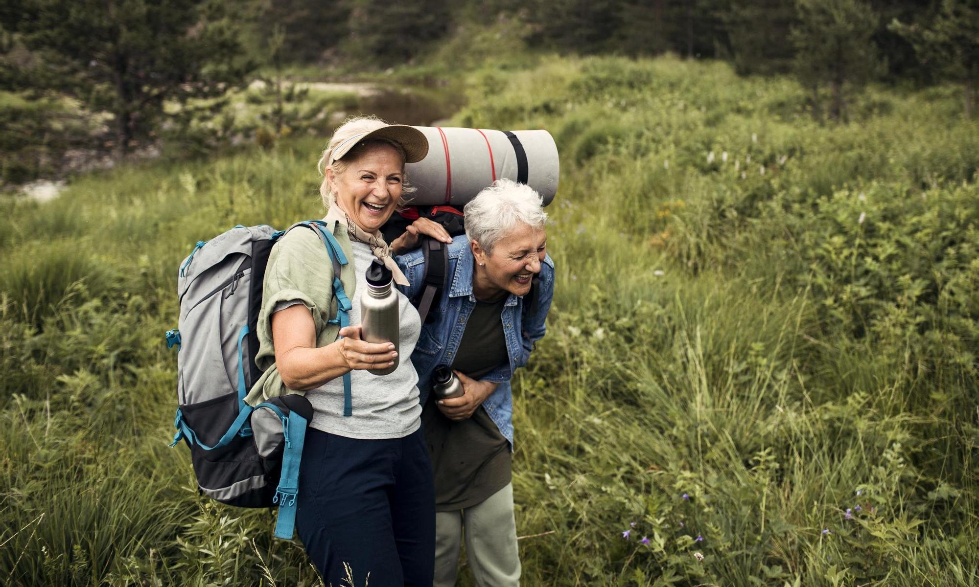 Close up of two senior female friends hiking together